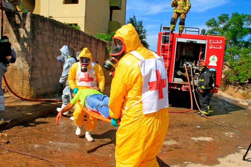 Lebanese civilians and members of the civil defence take part in a drill simulating a chemical weapons attack in the town of Kfar Falous.  AFP