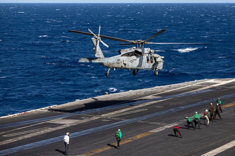 A helicopter takes off from the aircraft carrier USS Dwight D Eisenhower, during operations in the southern Red Sea, on Wednesday. Bloomberg