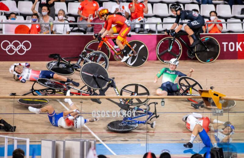 Jiali Liu of Team China and Holly Edmondston of Team New Zealand compete as Lotte Kopecky of Team Belgium, Clara Copponi of Team France and Laura Kenny of Team Great Britain crash during the Women's Omnium scratch race, 1 round of 4 of the track cycling on day sixteen of the Tokyo 2020 Olympic Games at Izu Velodrome.