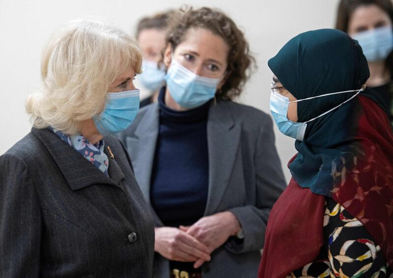 Camilla speaks to people as she is shown around the vaccination centre. AFP
