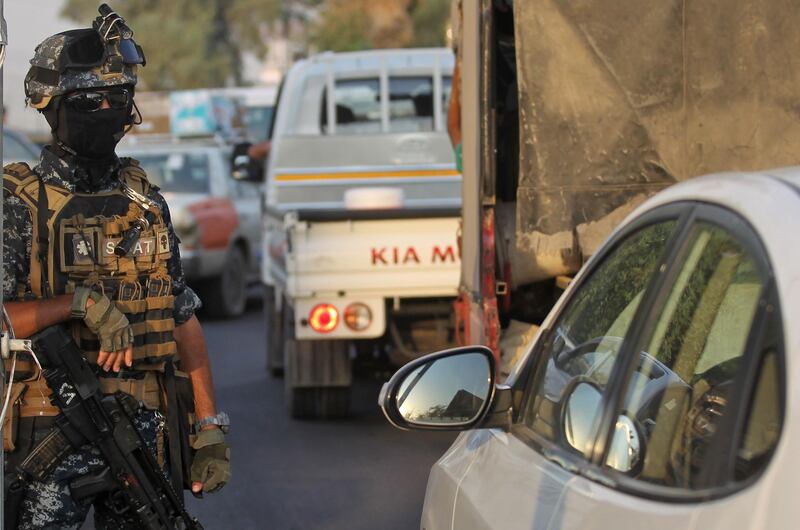 An Iraqi policeman mans a checkpoint in the capital Baghdad's predominantly Shiite Sadr City.  Iraq's parliament held its first session today after a week of anti-government protests that left dozens dead and sparked a political crisis the country's president said required a "national dialogue". AFP