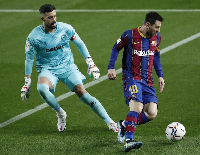 Barcelona's Leo Messi up against Alaves' goalkeeper Fernando Pacheco. EPA