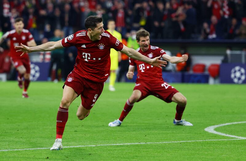Bayern Munich's Robert Lewandowski celebrates scoring their first goal against Villareal in the Uefa Champions League quarter-final in April 2022, with Thomas Muller. Reuters