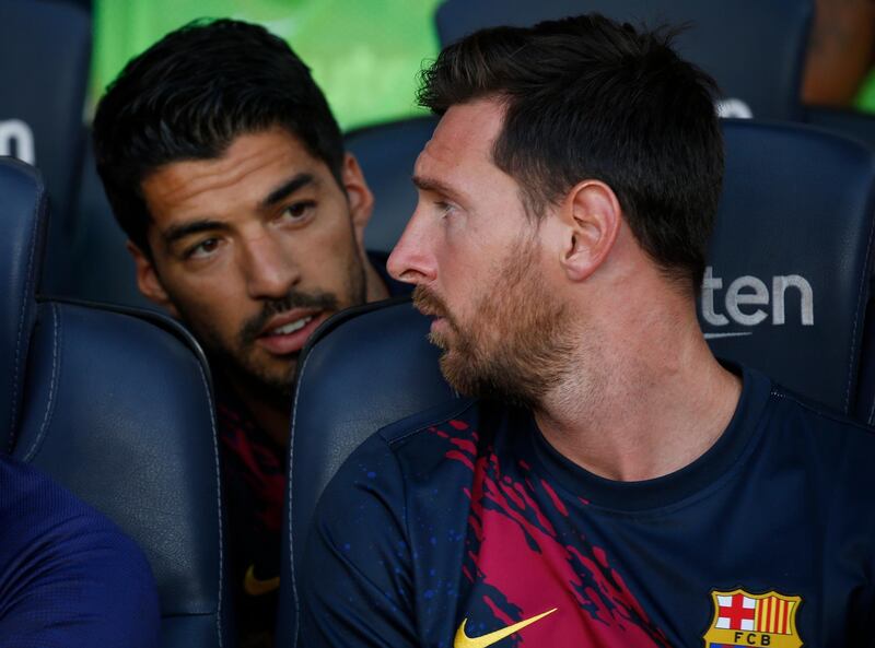 Suarez talks to Messi on the bench. AP Photo