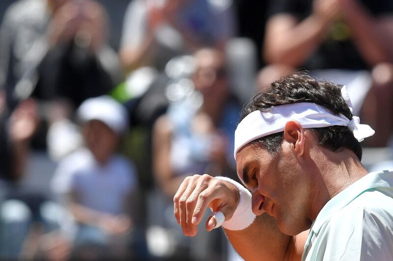 (FILES) In this file photograph taken on May 16, 2019, Switzerland's Roger Federer reacts during the ATP Masters tournament tennis match against Portugal's Joao Sousa at the Foro Italico in Rome.  Switzerland's Roger Federer announced May 17, 2019, that he is out of the Italian Open with a right leg injury. / AFP / Tiziana FABI
