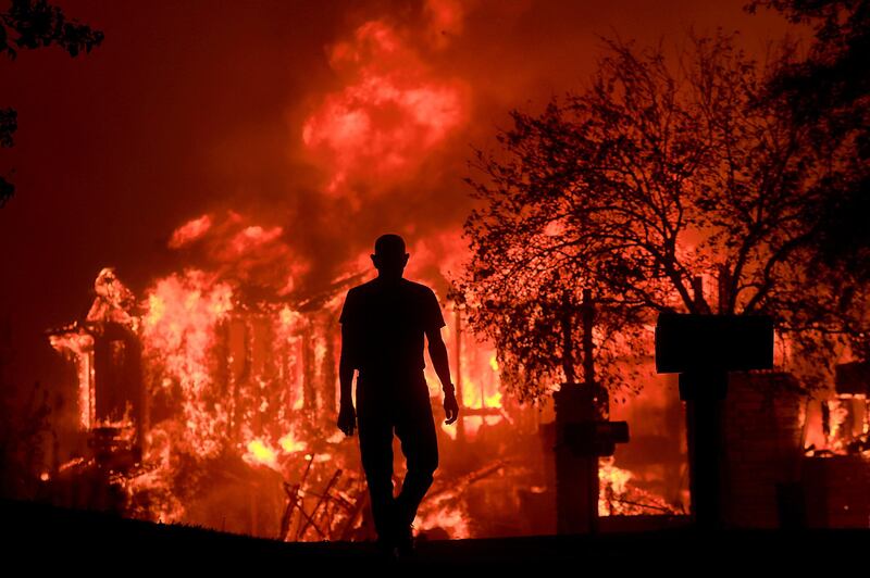 
                  <p>Jim Stites watches part of his neighborhood burn in Fountaingrove, Calif., Monday Oct. 9, 2017. More than a dozen wildfires whipped by powerful winds been burning though California wine country. The flames have destroyed at least 1,500 homes and businesses and sent thousands of people fleeing. (Kent Porter/The Press Democrat via AP)</p>
               