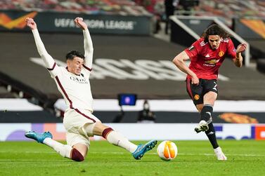 Manchester United's Edinson Cavani, kicks the ball during the Europa League semi final, first leg soccer match between Manchester United and Roma at Old Trafford in Manchester, England. AP