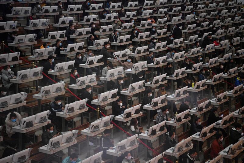 Traders wearing face masks aon the floor at a flower auction centre in Kunming, Yunnan province, China.  Reuters