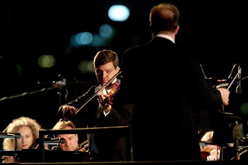 James Ehnes performs with the City of Birmingham Symphony Orchestra at the Corniche Breakwater. Christopher Pike / The National 

