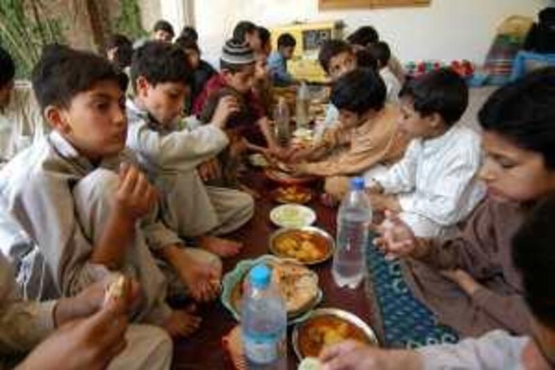 PESHAWAR: PAKISTAN: 25-May-2009.
Orphans at Lunch: Some of the 80 orphans from Swat Valley's main orphanage "Khpal-kor" or “Our House” are taking refuge at a government-run secondary school in Peshawar on May 25, 2009 while fighting continued in Swat’s main town, Mingora yesterday. Photo by Muzammil Pasha for The National *** Local Caption ***  kor 9687.jpg