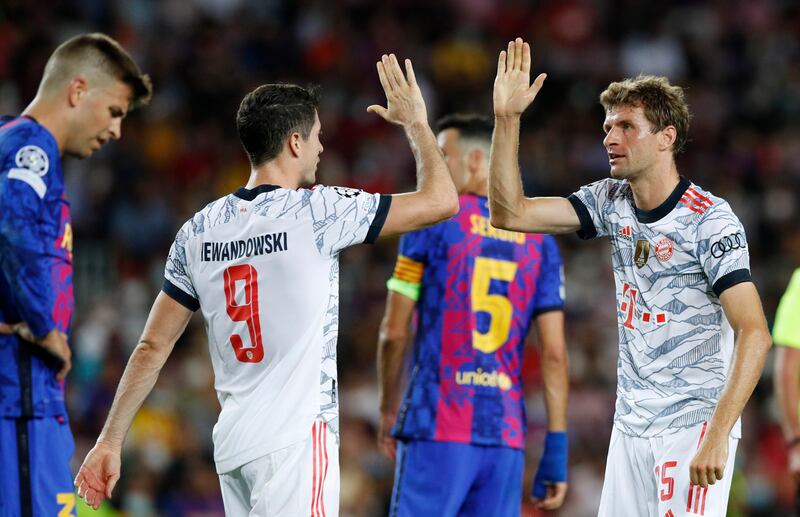 Bayern Munich's Thomas Muller celebrates scoring their first goal with Robert Lewandowski. Reuters