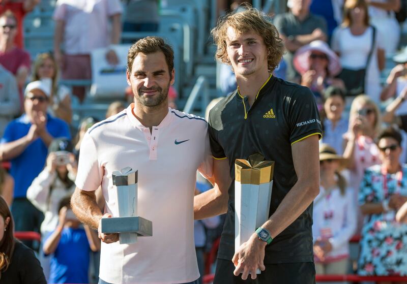 Winner Alexander Zverev, right, of Germany, poses for a photo with his opponent Roger Federer, of Switzerland, during victory ceremonies at the Rogers Cup tennis tournament in Montreal, Sunday, Aug. 13, 2017. (Paul Chiasson/The Canadian Press via AP)