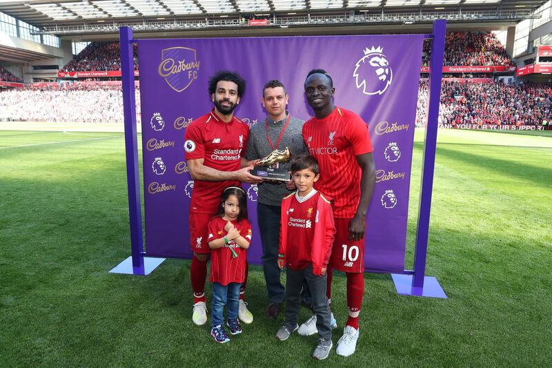 Mohamed Salah and Sadio Mane of Liverpool pose with the golden boot trophy. Getty Images