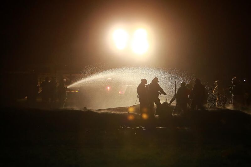 Firefighters work to control a blaze after a pipeline belonging to Mexican oil company PEMEX in Tlahuelilpan, Mexico.  Hector Vivas / Getty Images