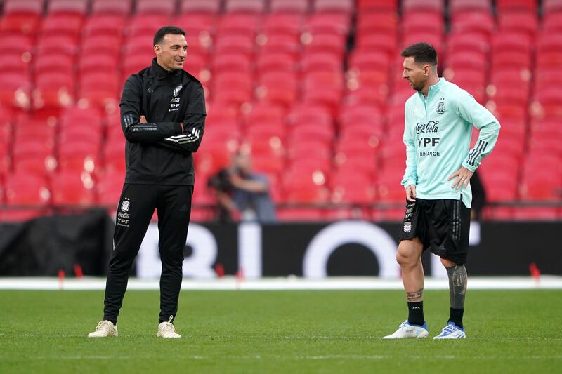 Argentina's Lionel Messi speaks to manager Lionel Scaloni. PA