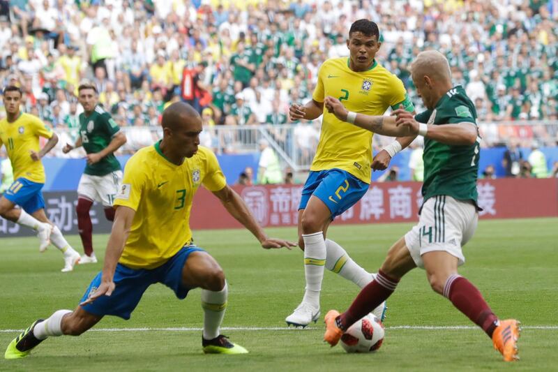 Mexico's Javier Hernandez, right, is challenged by Brazil's Miranda, left, and Brazil's Thiago Silva, center. Andre Penner / AP Photo