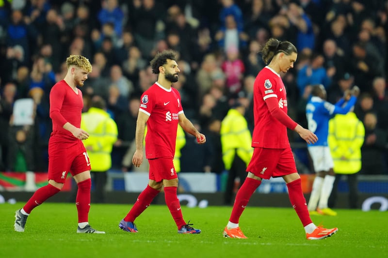 Liverpool players Harvey Elliott, Mohamed Salah, and Darwin Nunez leave the Goodison Park pitch after defeat to Everton. AP