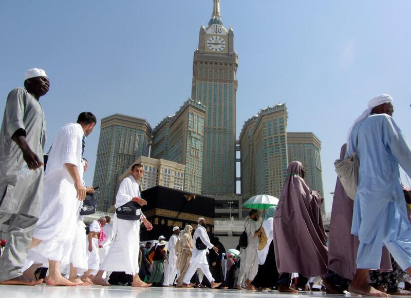 The tallest clock tower in the world with the world's largest clock face, atop the Abraj Al-Bait Towers, overshadows Muslim pilgrims as they circumambulate around the Kaaba in Makkah.  AP