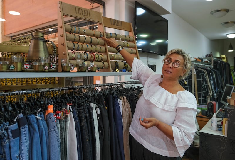 Fashion shop owner Rima Mawlawi El Samad shows off the range of coin bracelets.