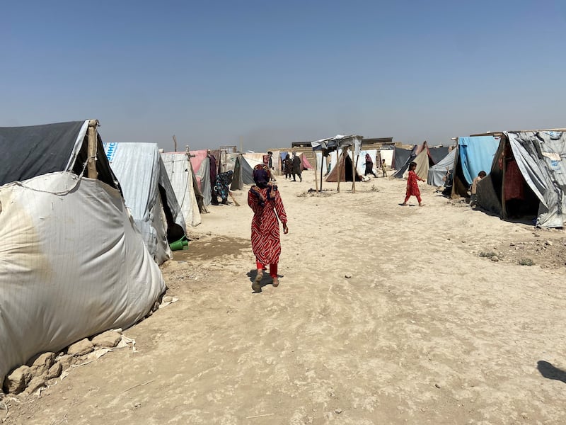 A young girl walks through a camp for internally displaced people, administered by the United Nations High Commission for Refugees in northern Afghanistan. Photo: Ruchi Kumar for The National.