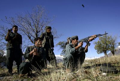 A PKK guerilla shoots an AK-47 assault rifle during a patrol through a mountain pass along the Iraq-Iran border in the mountains of northern Iraq's Kurdish autonomous region. AFP