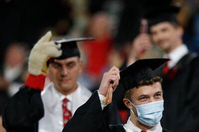 Graduates turn their tassels during the University of Georgia's rescheduled Spring Commencement at Sanford Stadium in Athens, Ga., Friday, Oct. 16, 2020. The ceremony was moved from the spring due to the ongoing COVID-19 pandemic. (Joshua L. Jones/Athens Banner-Herald via AP)
