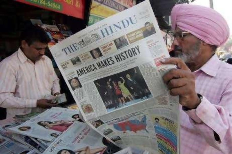 An Indian Sikh reads newspapers displaying front page headlines and photographs of US president-elect Barack Obama in Amritsar on November 6, 2008. World leaders hailed Barack Obama's triumph in the US presidential election as the dawn of a new era and called for the global superpower to change the way it does business.   AFP PHOTO/NARINDER NANU