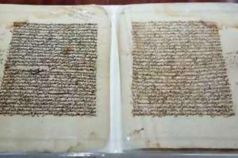 An 18th century copy of Ahmed baba's 16th Century work saying that on the day of judgement the ink of the scholars will be measured against the blood of martyrs and found to be weightier, part of an exhibition of ancient Islamic and rabaic texts shown at the Standard Bank gallery in downtown Johannesburg are part of the joint South Africa - Mali restoration and archiving program of some of the oldest and most valuable Islamic manuscripts, November 21. Dr Mohamed Diagayete of IHERIAB Photo Greg Marinovich *** Local Caption ***  17921_20081121_0388.jpg