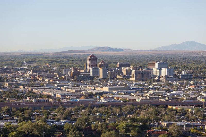 The host location for one of the world's largest  balloon festivals, the city is warmly illuminated during the morning sunrise, with a majestic range of mountains in the background. iStockphoto.com