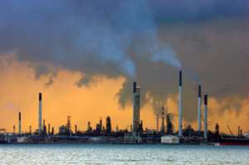 A view of an oil refinery off the coast of Singapore March 14, 2008. Oil slipped below $110 on Friday as investors took profits after prices hit a record $111 in the previous session, but the depressed dollar was seen limiting losses.   REUTERS/Vivek Prakash (SINGAPORE)