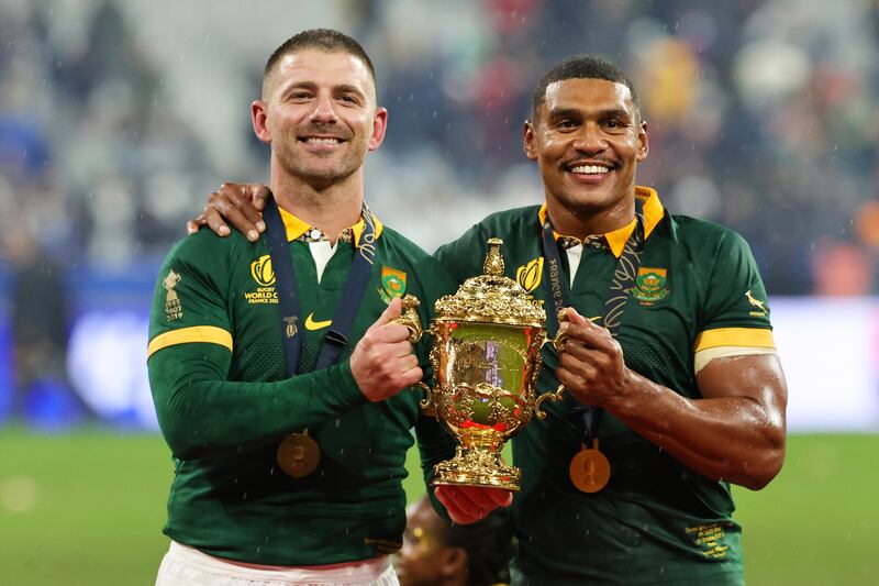 Willie Le Roux and Damian Willemse of South Africa pose for a photo with the The Webb Ellis Cup. Getty