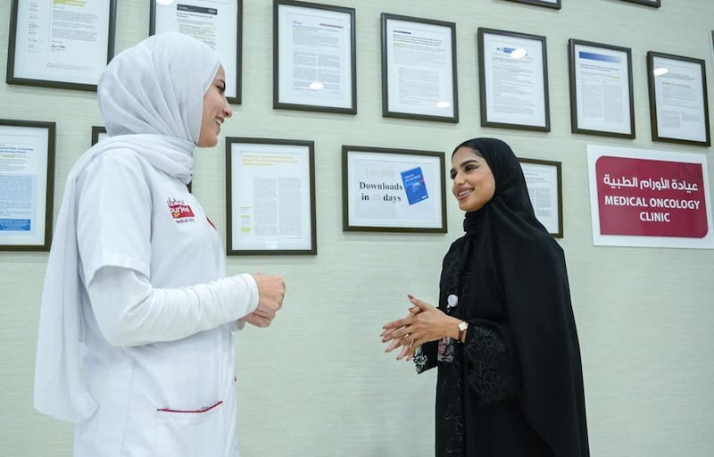 Athari Al Hosani, right, is a guest services executive at Burjeel Medical City.
