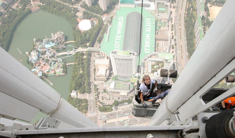 World-renowned French climber Alain Robert scales the outer wall of Lotte World Tower in southern Seoul.  EPA