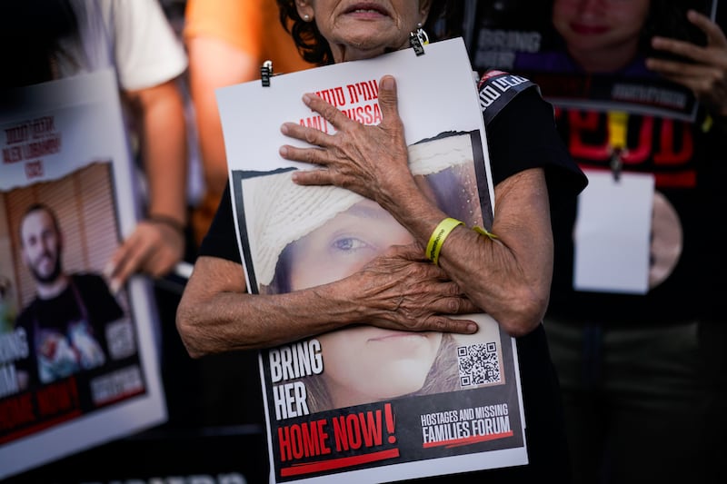 Relatives and friends of those kidnapped during the October 7 Hamas attack hold photos of their loved ones during a protest calling for their return outside Israel's parliament. AP