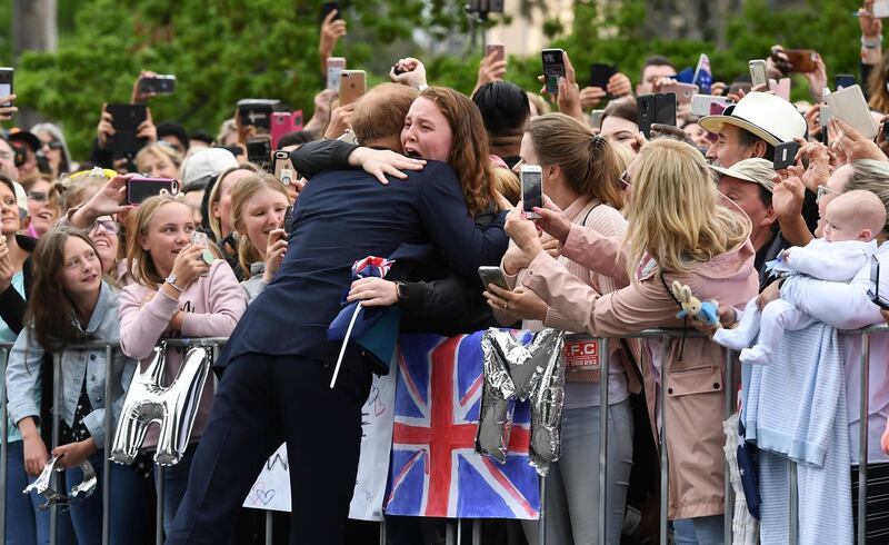 Prince Harry embraces a wellwisher during a public walk in Melbourne, Australia. AFP