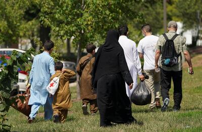 Afghans leave a processing centre for refugees evacuated from Afghanistan near Dulles International Airport in Chantilly, Virginia, US, on August 24, 2021. Reuters