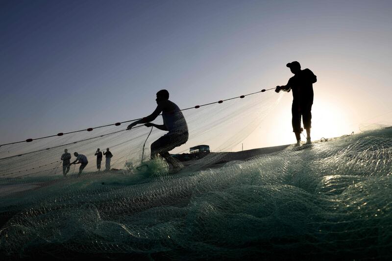 Fishermen hoist a net in from the Mediterranean Sea. AFP