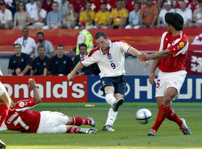 England's Wayne Rooney (9) scores his second goal of the match as Switzerland's Murat Yakin (5) and Ricardo Cabanas defend during their Group B Euro 2004 first round match at the Cidade de Coimbra Stadium, in Coimbra, Portugal,  Thursday, June 17, 2004. Croatia and France also play in Group B.(AP Photo/Michael Probst) ** FOR EDITORIAL USE ONLY. NO WIRELESS, COMMERCIAL OR PROMOTIONAL LICENSING PERMITTED  **