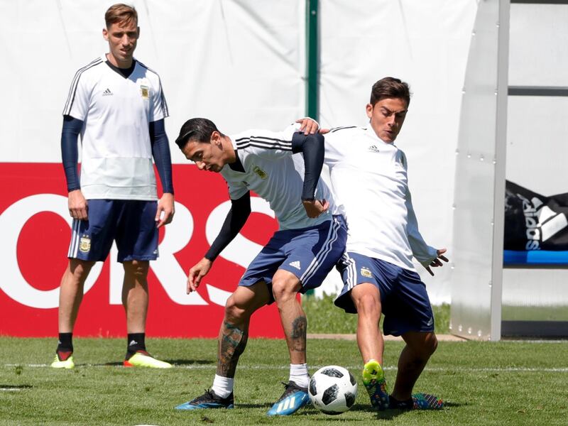 Angel Di Maria, left, and Paulo Dybala play ball during a training session of Argentina on the eve of their group D match against Iceland at the 2018 soccer World Cup in Bronnitsy, Russia, Friday, June 15, 2018. (AP Photo/Ricardo Mazalan)