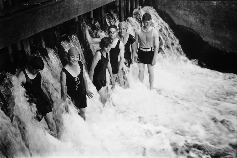 A group of friends cool off in Mill Weir, Berkshire, during a heatwave in 1926. 