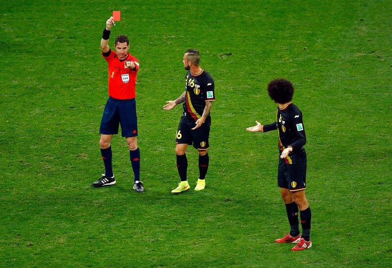 Steven Defour of Belgium is shown a red card by referee Ben Willians as Marouane Fellaini joins in protest on Thursday in their match against South Korea at the 2014 World Cup. Matthew Lewis / Getty Images