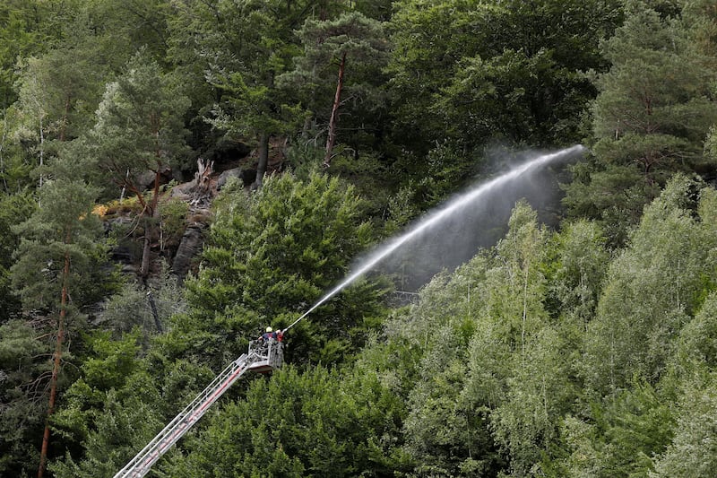 A firefighter works to contain a wildfire in a forest near the town of Hrensko, Czech Republic. Reuters