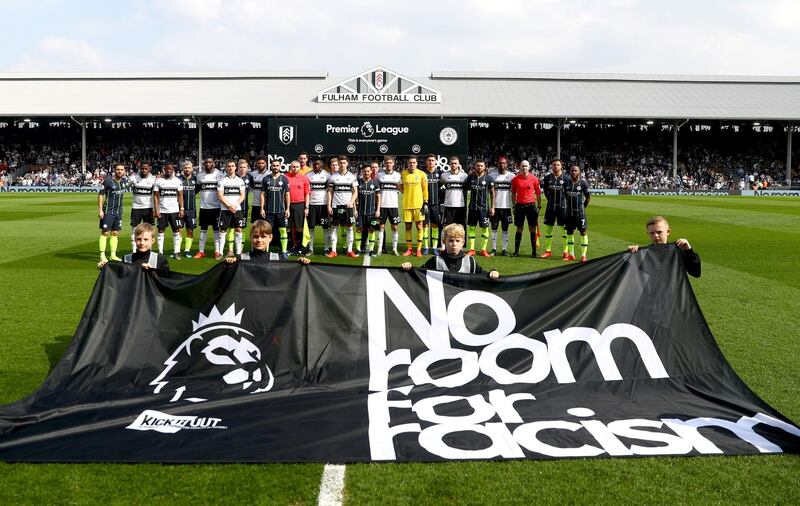 Fulham and Manchester City players stand with the match officials in protest against racism prior to the match. Getty Images