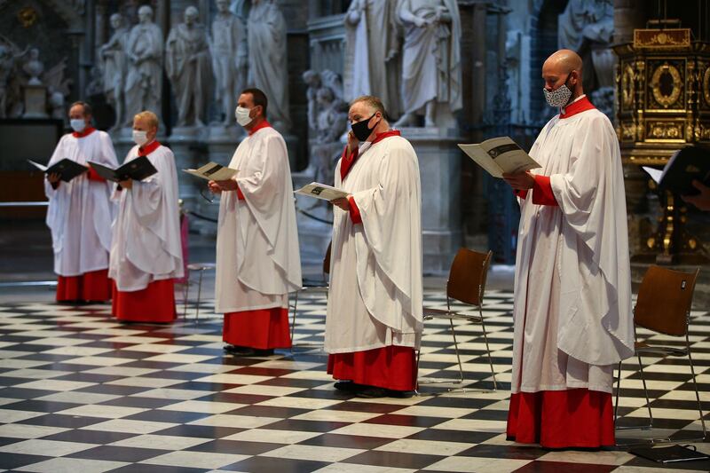 Choir members wear face masks as they sing at Westminster Abbey in London, England. Six members of the Westminster Abbey were allowed back to sing at the 11:15 Eucharist service for the first time since Coronavirus lockdown. The four-month hiatus is the longest the Abbey choir has been silent since the Second World War.  Getty Images