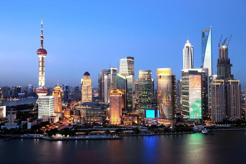 Night view of Huangpu River and the Lujiazui Financial District with the Oriental Pearl TV Tower, Jinmao Tower, the Shanghai World Financial Center and other skyscrapers and high-rise buildings in Pudong, Shanghai, China, 25 July 2012.