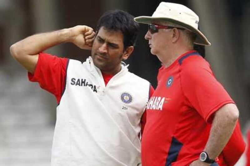 MS Dhoni, left, the India captain, talks with coach Duncan Fletcher during a training session at The Oval yesterday.
