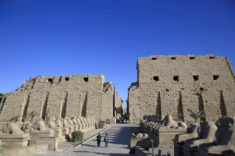 Tourist look out at the ruins of the Karnak Temple in Luxor, Egypt. Foreign tourism, a major part of Egypt’s economy, has been hurt during years of turmoil following the 2011 revolt that saw Hosni Mubarak step down. Hassan Ammar / AP Photo