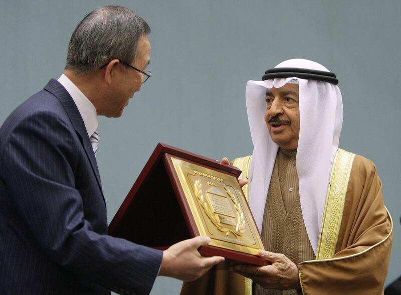 United Nations (UN) Secretary-General Ban Ki-moon (L) gives to Bahraini Prime Minister Sheikh Khalifa bin Salman al-Khalifa 
the 2006 Special Citation and Habitat Scroll of Honor on the sideline of the first annual ministerial review of the Economic and Social Council (ECOSOC), 02 July 2007 at the United Nations office in Geneva. The prime minister was awarded by UN-HABITAT, a specialized United Nations agency mandated to promote socially and environmentally sustainable towns and cities.  AFP PHOTO / FABRICE COFFRINI (Photo by FABRICE COFFRINI / AFP)