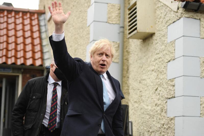 Britain's Prime Minister Boris Johnson waves as he leaves Jacksons Wharf pub in Hartlepool, northeast England on May 7, 2021 during a visit following the Conservative Party by-election victory in the constituency. Prime Minister Boris Johnson on May 7 welcomed early election results in Britain's first major vote since Brexit and the pandemic, including a stunning by-election victory for his Conservative party in the opposition Labour stronghold of Hartlepool in northeast England.  / AFP / Oli SCARFF
