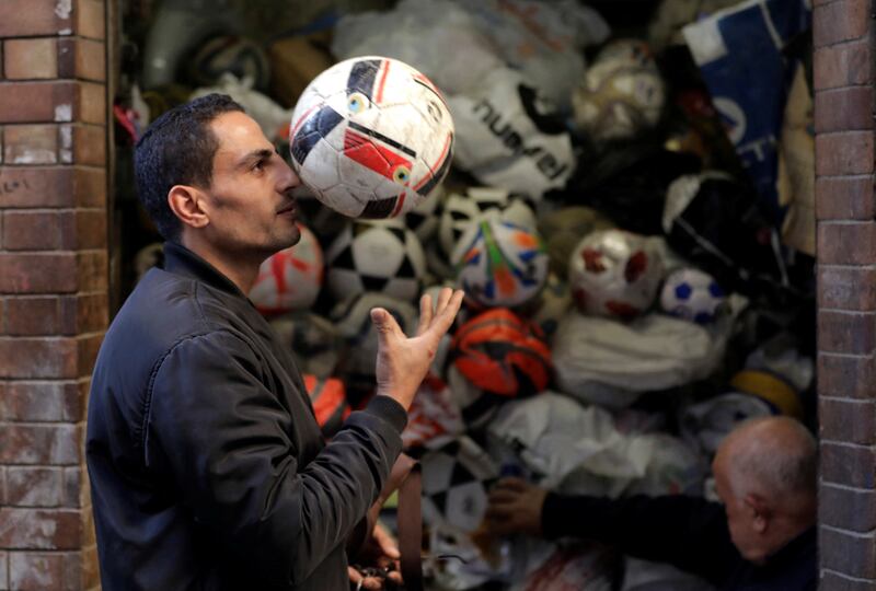 A customer checks a football fixed by Mr Mahmoud